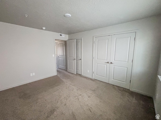 1700 S Sandhill Unit H203, Orem, UT 84058 - unfurnished bedroom featuring visible vents, two closets, a textured ceiling, carpet, and baseboards