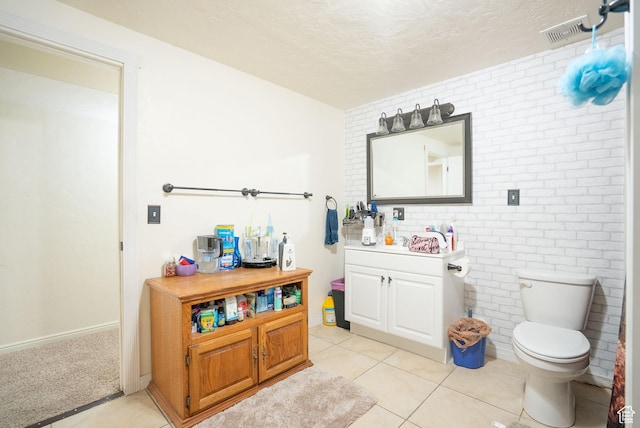 2922 S 500 E, Vernal, UT 84078 - bathroom featuring vanity, toilet, a textured ceiling, tile patterned floors, and brick wall