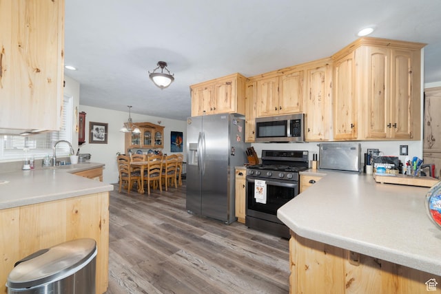 2922 S 500 E, Vernal, UT 84078 - kitchen featuring appliances with stainless steel finishes, light brown cabinets, light countertops, wood finished floors, and recessed lighting