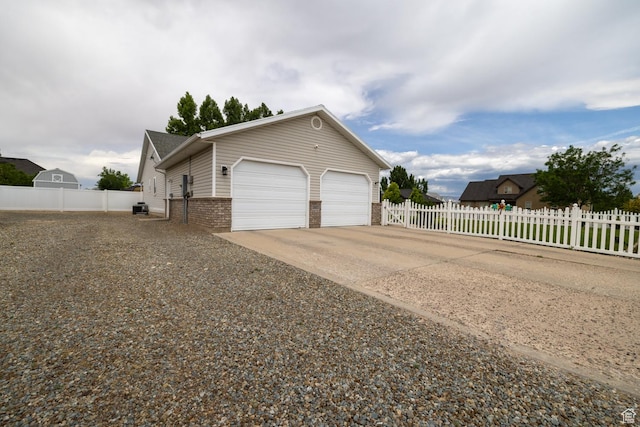 2922 S 500 E, Vernal, UT 84078 - view of side of home featuring brick siding, driveway, a garage, and cooling unit