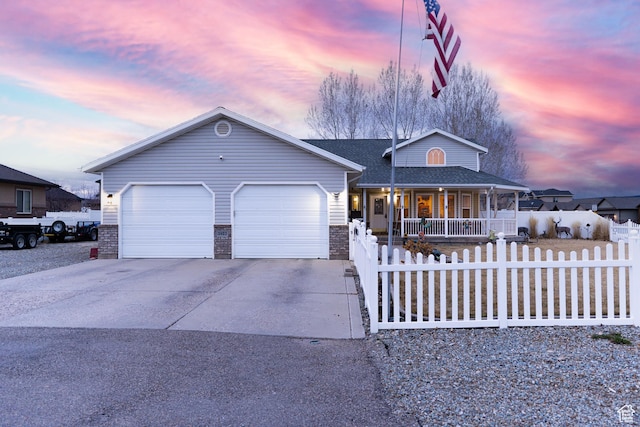 2922 S 500 E, Vernal, UT 84078 - view of front of property with covered porch, a fenced front yard, concrete driveway, and an attached garage