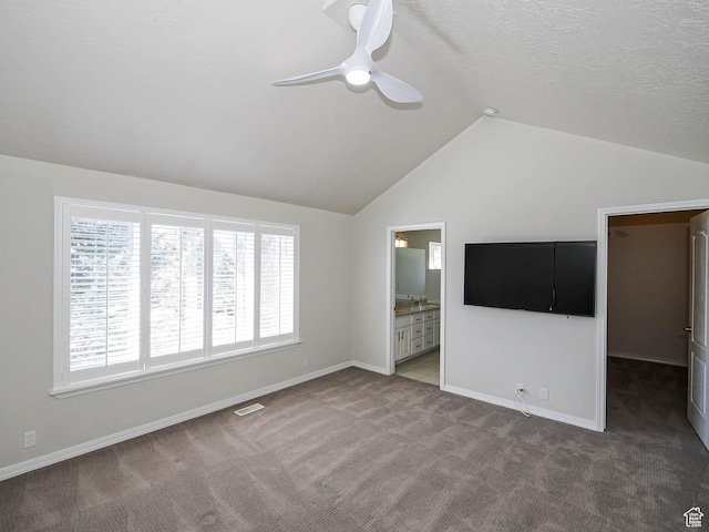8004 Mustang Loop Rd, Park City, UT 84098 - unfurnished bedroom featuring visible vents, a textured ceiling, baseboards, carpet, and lofted ceiling