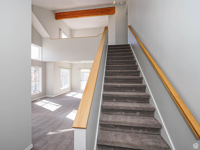 8004 Mustang Loop Rd, Park City, UT 84098 - staircase featuring carpet flooring, beamed ceiling, a high ceiling, and baseboards