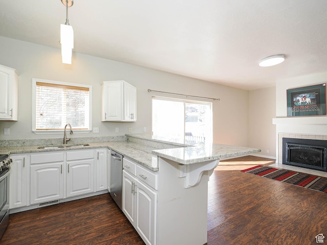 8004 Mustang Loop Rd, Park City, UT 84098 - kitchen with a sink, dark wood-style floors, white cabinetry, stainless steel appliances, and a peninsula
