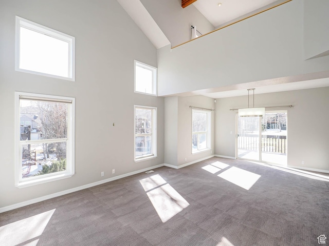 8004 Mustang Loop Rd, Park City, UT 84098 - carpeted empty room with a healthy amount of sunlight, high vaulted ceiling, and baseboards