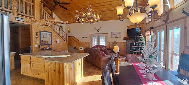 5085 Trumpeter, Island Park, ID 83429 - kitchen with wooden walls, a healthy amount of sunlight, french doors, wainscoting, and wooden ceiling
