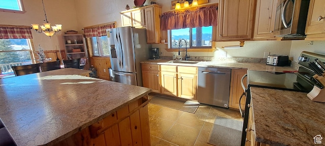 5085 Trumpeter, Island Park, ID 83429 - kitchen featuring a sink, decorative light fixtures, a kitchen island, stainless steel appliances, and an inviting chandelier