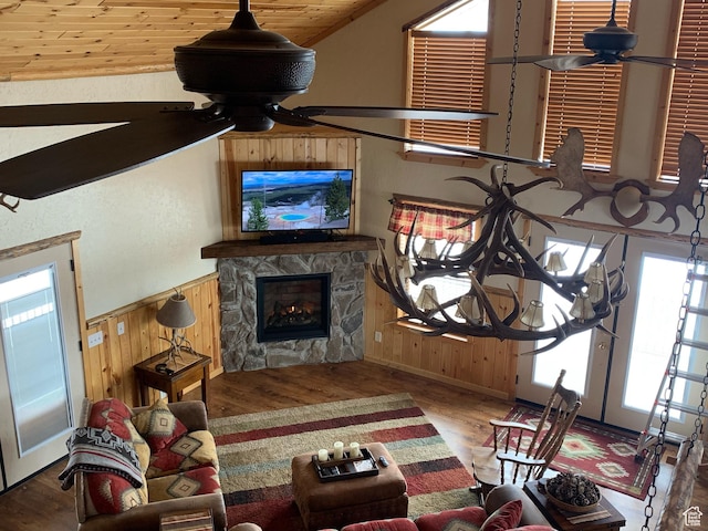 5085 Trumpeter, Island Park, ID 83429 - living room featuring a wainscoted wall, wood walls, ceiling fan, and wood finished floors