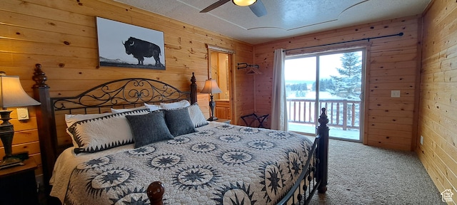 5085 Trumpeter, Island Park, ID 83429 - carpeted bedroom with wooden walls, a textured ceiling, a ceiling fan, and access to outside