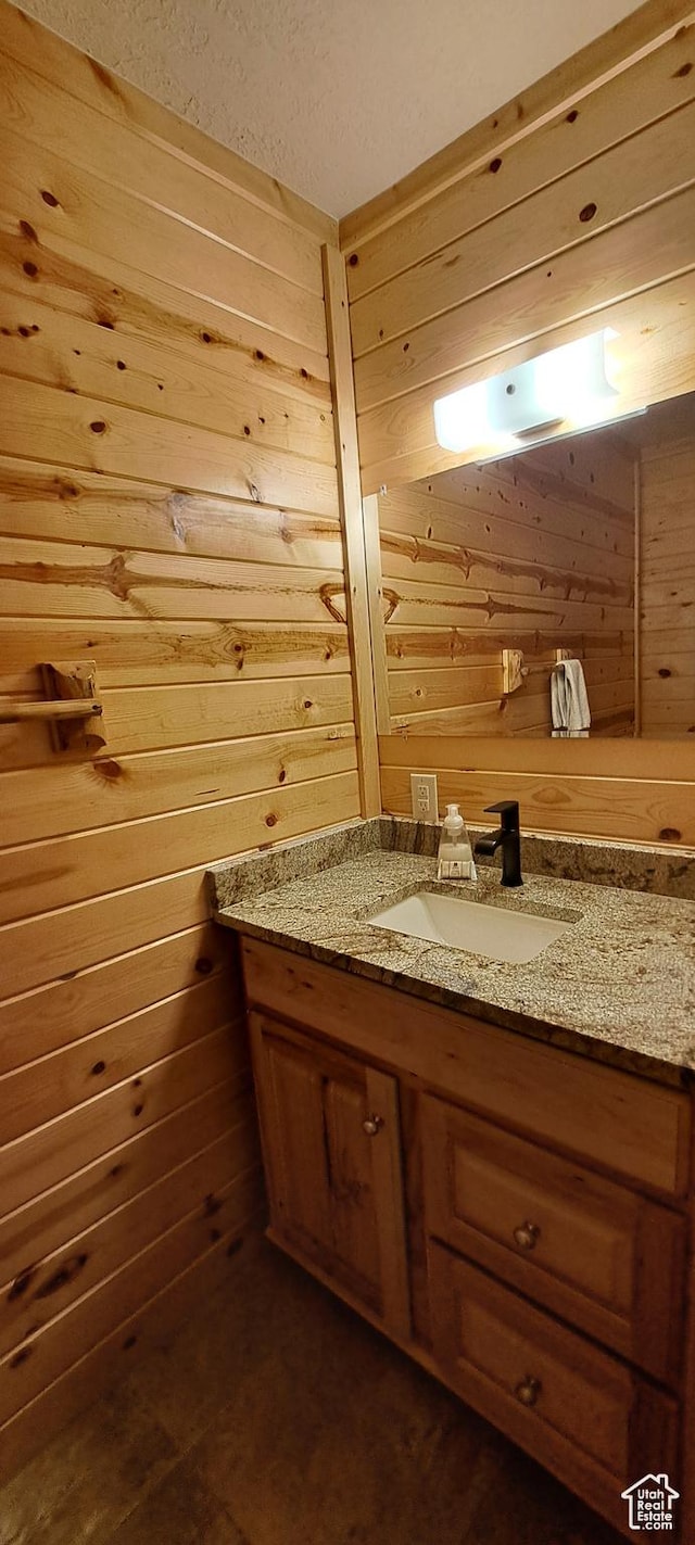 5085 Trumpeter, Island Park, ID 83429 - bathroom featuring vanity and wood walls