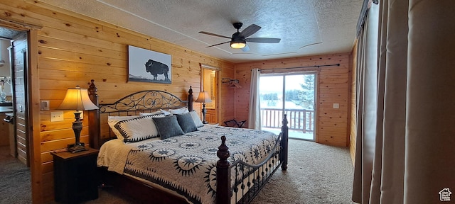 5085 Trumpeter, Island Park, ID 83429 - carpeted bedroom with access to exterior, wooden walls, a textured ceiling, and ceiling fan