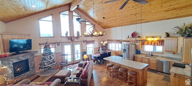 5085 Trumpeter, Island Park, ID 83429 - interior space featuring a sink, appliances with stainless steel finishes, a breakfast bar area, a fireplace, and wood ceiling