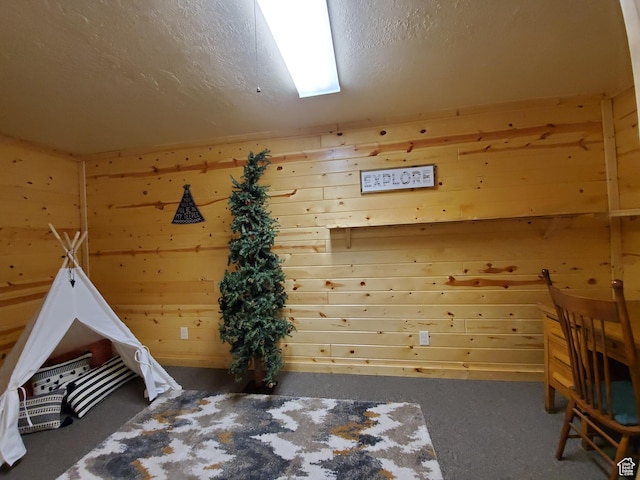 5085 Trumpeter, Island Park, ID 83429 - unfurnished bedroom with wooden walls and a textured ceiling