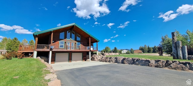 5085 Trumpeter, Island Park, ID 83429 - view of front facade with a garage, a front lawn, and driveway
