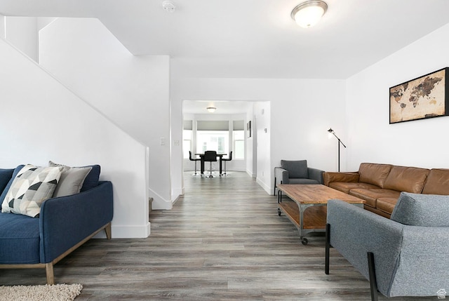 living area with baseboards and wood finished floors