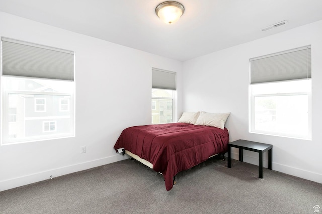 bedroom with visible vents, baseboards, and carpet