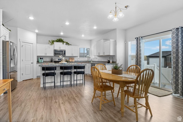 7382 W Butter Hollow Cir, Herriman, UT 84096 - dining area with light wood-type flooring, recessed lighting, and a chandelier