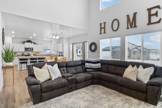 7382 W Butter Hollow Cir, Herriman, UT 84096 - living room with light wood-style floors, recessed lighting, and a chandelier