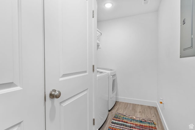 7382 W Butter Hollow Cir, Herriman, UT 84096 - laundry room with washing machine and clothes dryer, electric panel, light wood-style floors, and baseboards
