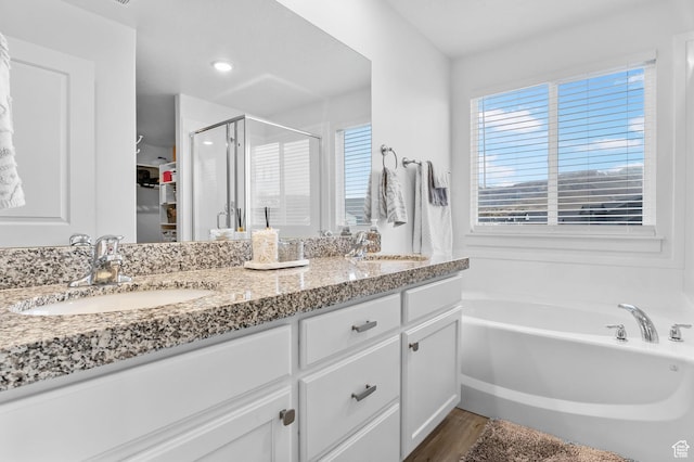 7382 W Butter Hollow Cir, Herriman, UT 84096 - full bath featuring a shower stall, double vanity, a garden tub, and wood finished floors