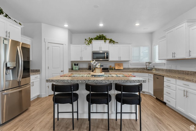 7382 W Butter Hollow Cir, Herriman, UT 84096 - kitchen featuring stainless steel appliances, a breakfast bar, white cabinets, and recessed lighting
