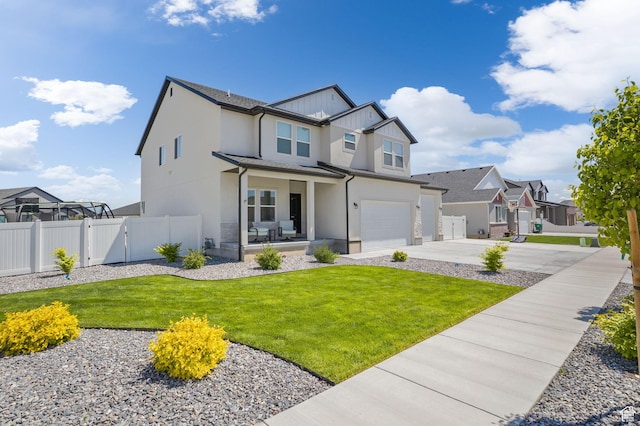 7382 W Butter Hollow Cir, Herriman, UT 84096 - view of front of home featuring an attached garage, concrete driveway, stucco siding, a gate, and a residential view