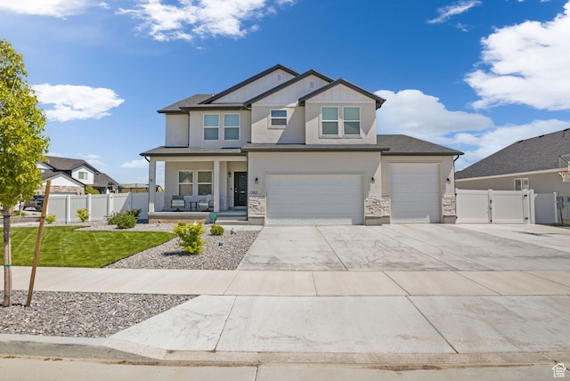 7382 W Butter Hollow Cir, Herriman, UT 84096 - craftsman-style house with covered porch, a gate, concrete driveway, a garage, and stone siding