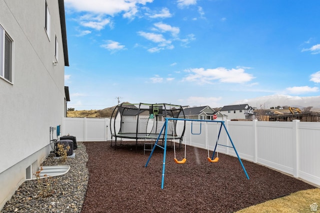 7382 W Butter Hollow Cir, Herriman, UT 84096 - view of playground with a trampoline, a fenced backyard, and a residential view