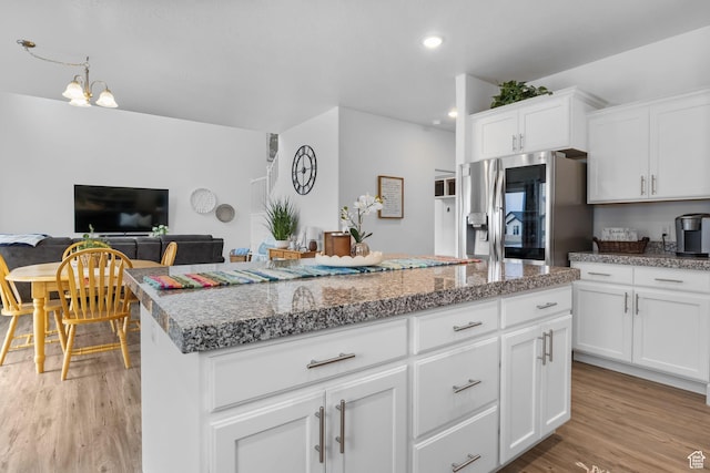 7382 W Butter Hollow Cir, Herriman, UT 84096 - kitchen featuring stainless steel fridge with ice dispenser, a center island, light wood-type flooring, white cabinets, and recessed lighting