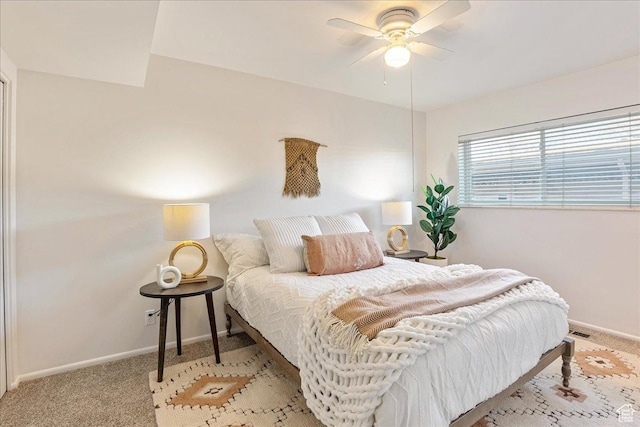 bedroom featuring ceiling fan, visible vents, baseboards, and light carpet
