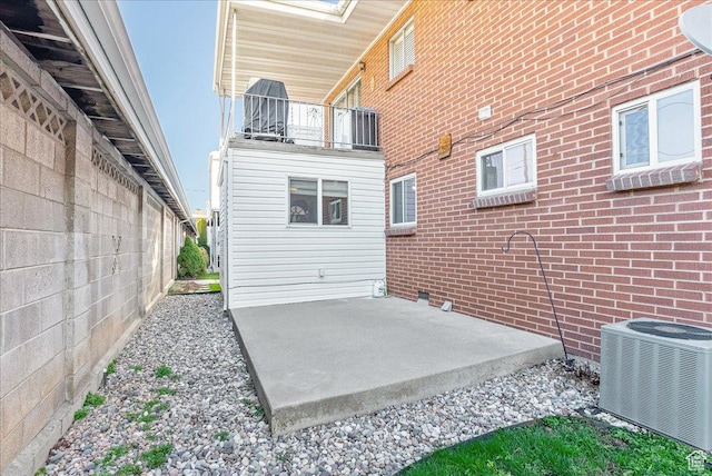 view of patio featuring a balcony and central AC