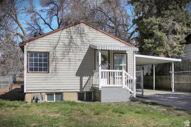 1278 E 22nd St S, Ogden, UT 84401 - exterior space featuring an attached carport, driveway, a front yard, and fence