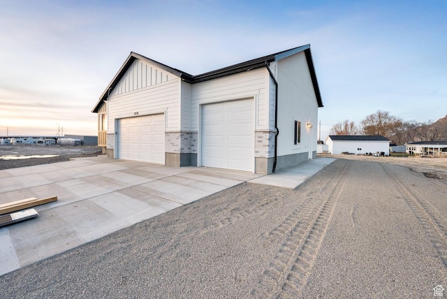 garage featuring concrete driveway