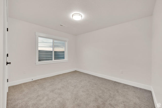 unfurnished room with baseboards and carpet flooring
