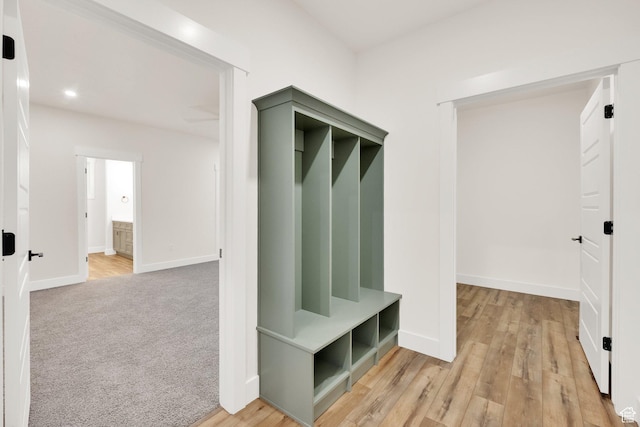 mudroom with baseboards, recessed lighting, and light wood-style floors