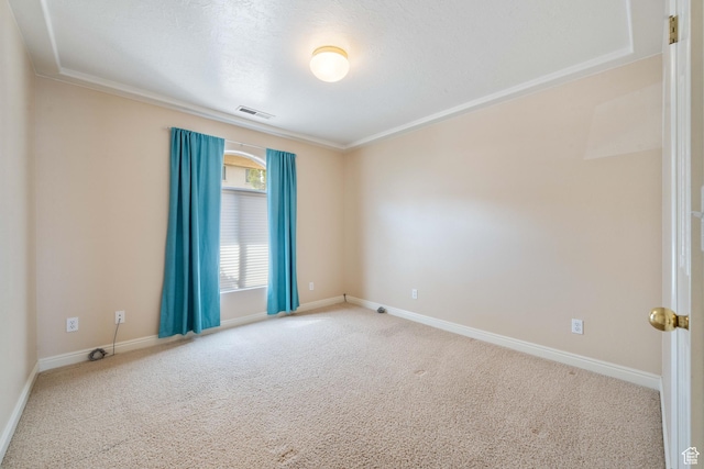carpeted spare room with visible vents and baseboards