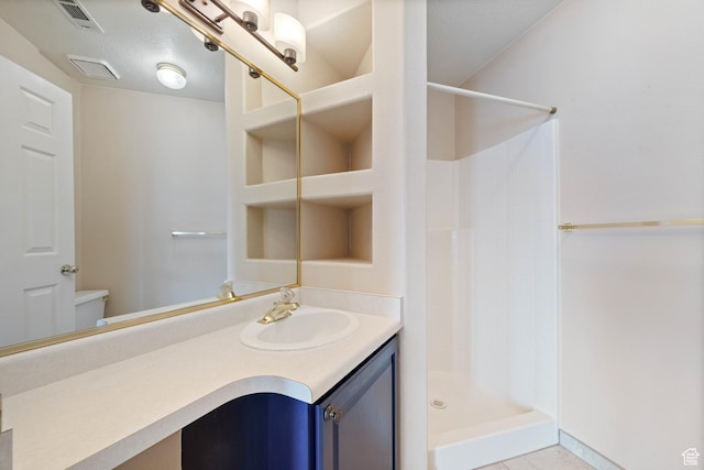 full bathroom with vanity, tile patterned floors, visible vents, and a stall shower
