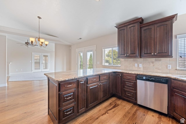 kitchen with dishwasher, a peninsula, light wood-type flooring, and backsplash