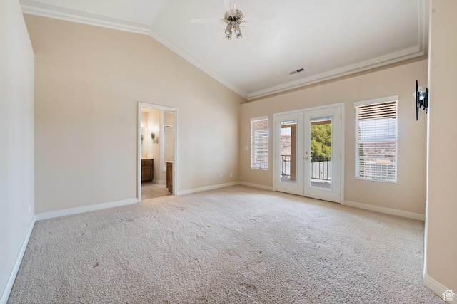 interior space featuring a wealth of natural light, visible vents, light carpet, and vaulted ceiling
