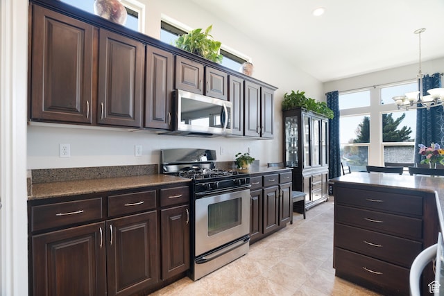 2581 W 2675 N, Farr West, UT 84404 - kitchen featuring stainless steel appliances, a notable chandelier, decorative light fixtures, dark countertops, and dark brown cabinets