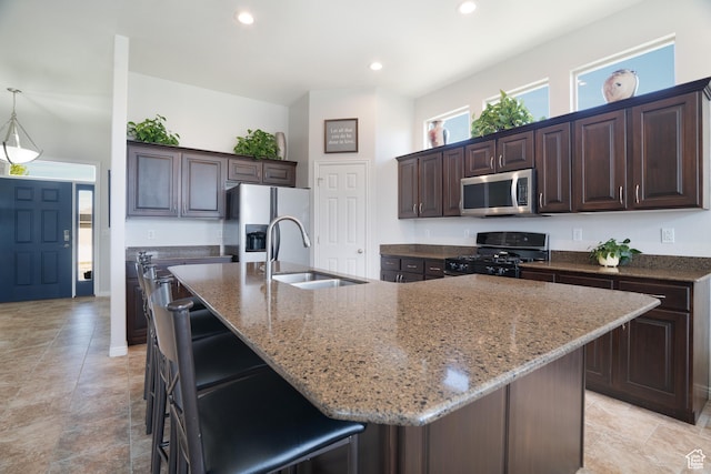 2581 W 2675 N, Farr West, UT 84404 - kitchen featuring light stone counters, stainless steel microwave, fridge with ice dispenser, a sink, and black range with gas stovetop