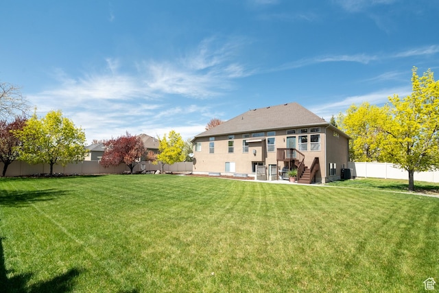 2581 W 2675 N, Farr West, UT 84404 - back of house with a lawn, stucco siding, and a fenced backyard