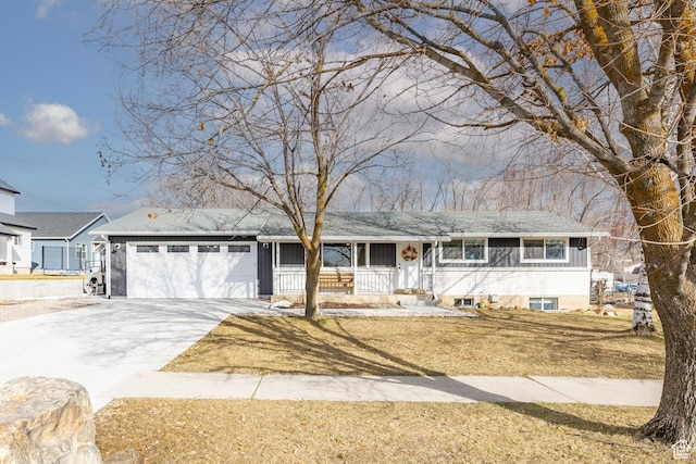 single story home with a front yard, covered porch, concrete driveway, and an attached garage