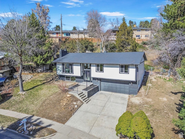 2605 E Portsmouth Ave S, Cottonwood Heights, UT 84121 - view of front of property with concrete driveway, fence, and a garage