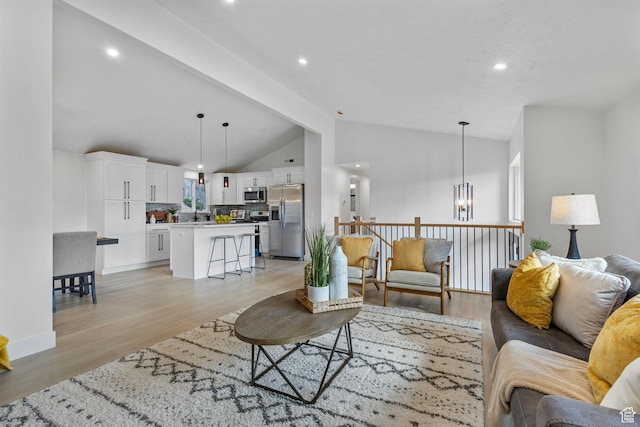 2605 E Portsmouth Ave S, Cottonwood Heights, UT 84121 - living room with vaulted ceiling, a notable chandelier, light wood-style floors, and recessed lighting