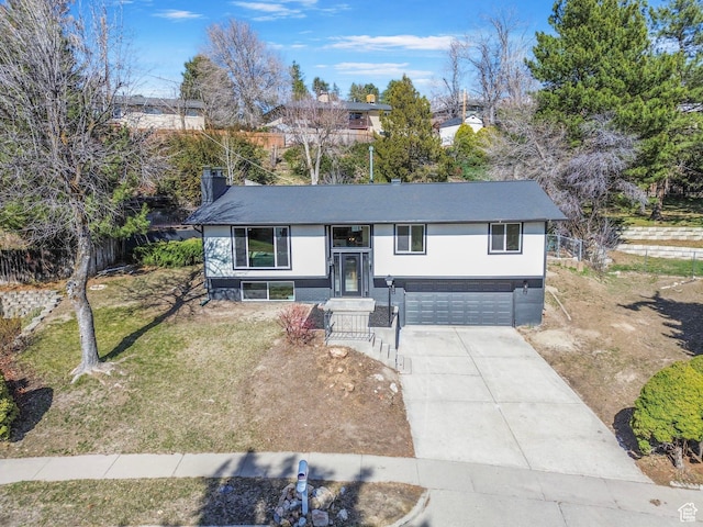 2605 E Portsmouth Ave S, Cottonwood Heights, UT 84121 - split foyer home with a garage, a chimney, concrete driveway, and a front lawn