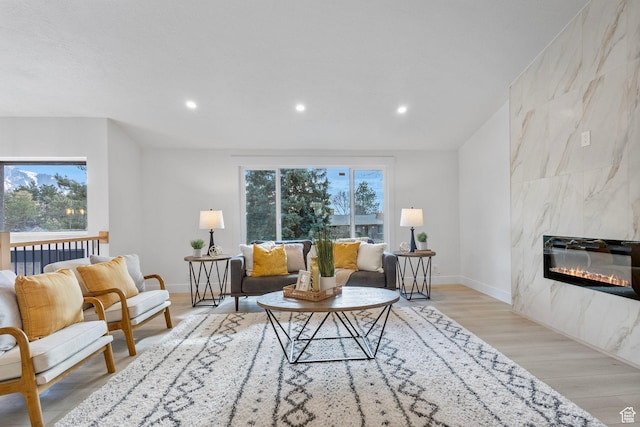 2605 E Portsmouth Ave S, Cottonwood Heights, UT 84121 - living room with recessed lighting, baseboards, light wood-style floors, and a fireplace