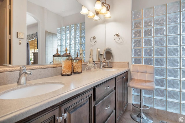 bathroom featuring a sink and double vanity