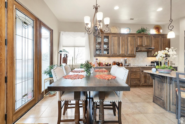 dining area featuring light tile patterned floors, a chandelier, and recessed lighting