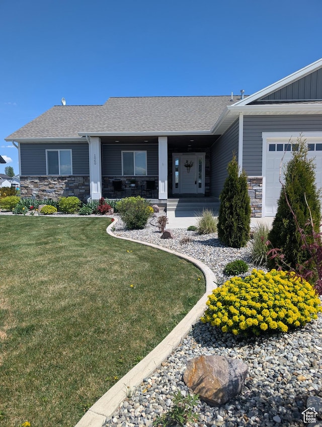 1060 N 100 E, Preston, ID 83263 - ranch-style home with stone siding, a front lawn, an attached garage, a porch, and a shingled roof